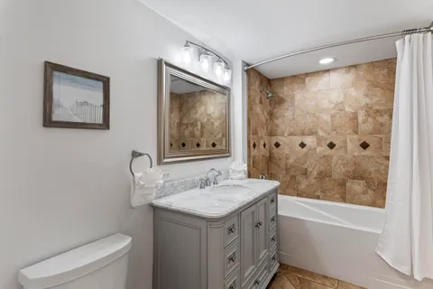 an aerial view of ocean and residential houses with outdoor space