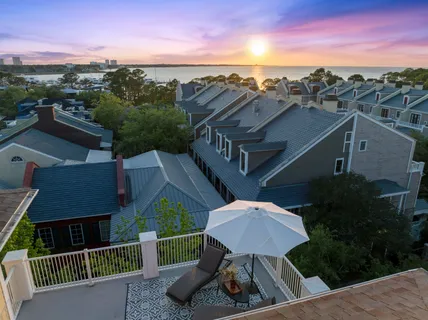 a view of a chair and table in backyard of the house
