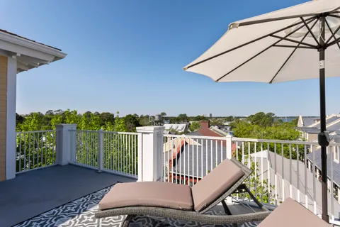 a view of a patio with a table and chairs and a large tree