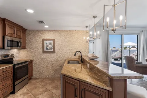 a kitchen with a table chairs stove and cabinets