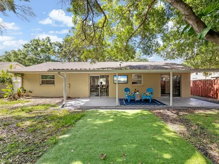 a view of a house with a yard and sitting area