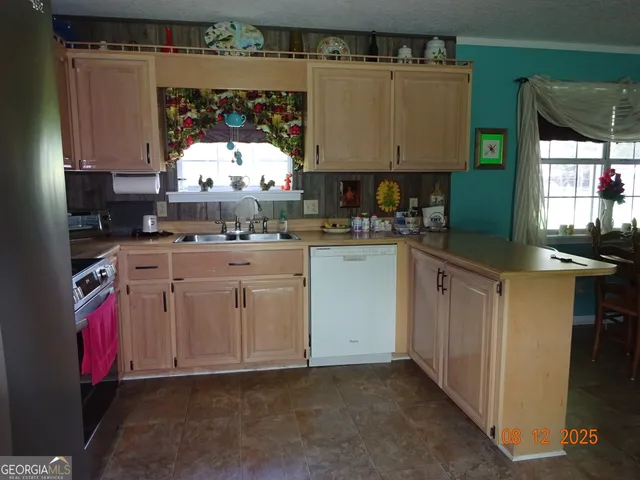 a kitchen with a sink stove and cabinets