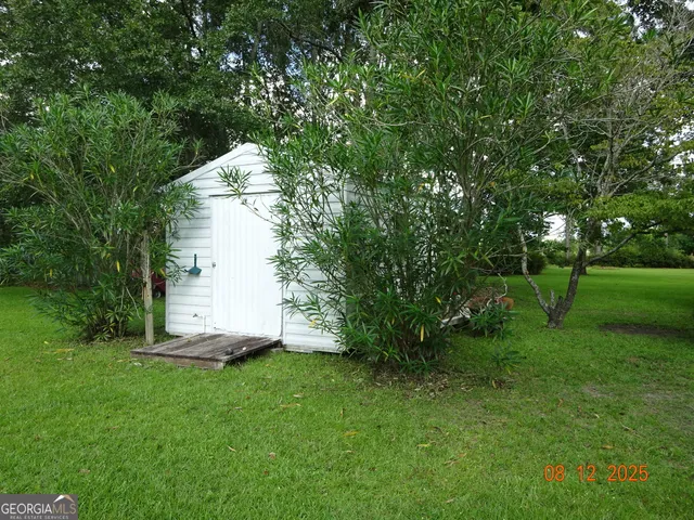 a view of a tiny house with a tree in a park