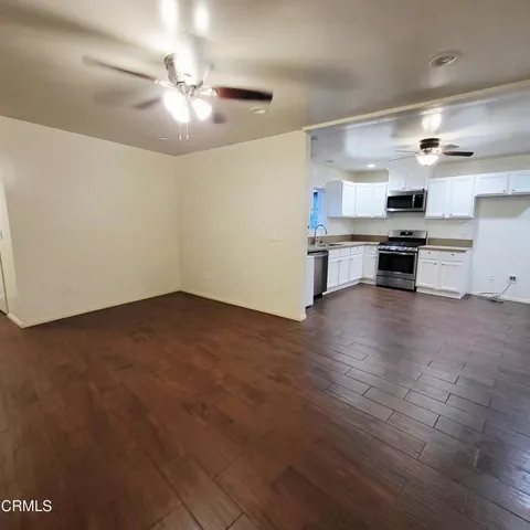 a kitchen with stainless steel appliances granite countertop a stove and a refrigerator