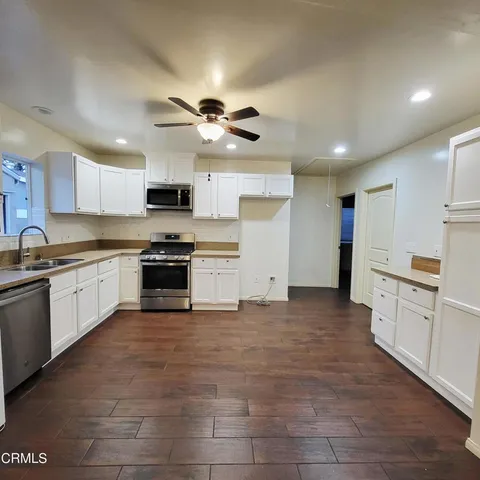 a large kitchen with cabinets and stainless steel appliances