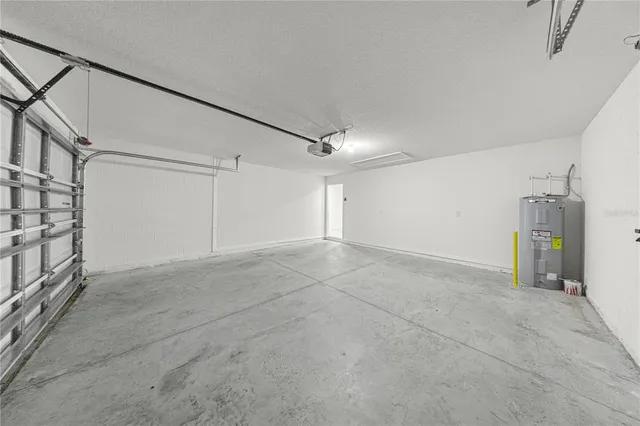 a view of kitchen with stainless steel appliances cabinets and a window
