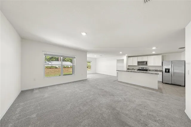 a view of kitchen and refrigerator