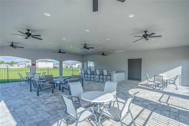 an outdoor dining space with furniture and garden view