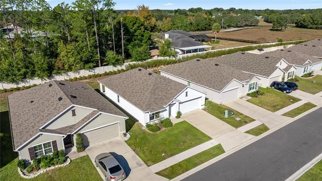 an aerial view of house with backyard