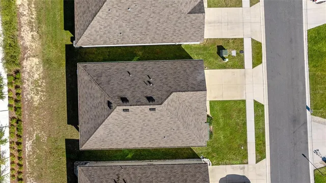a aerial view of a house with a yard