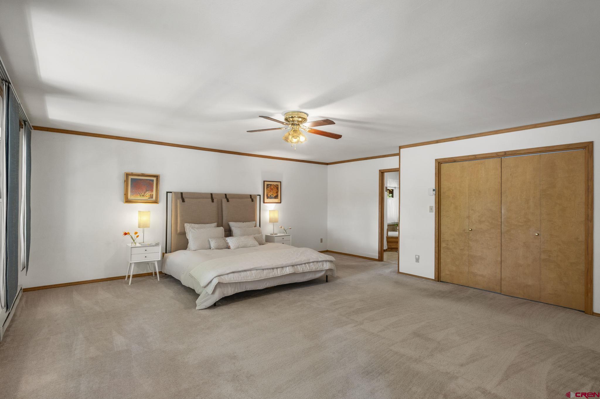 37 Verde Lane Durango, CO 81301 - Photo 15 of 45 a bedroom with a bed and a ceiling fan