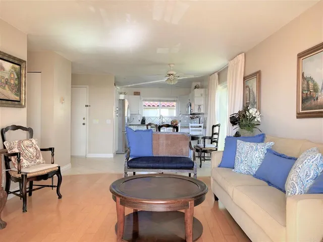 a living room with furniture and a painting on the wall