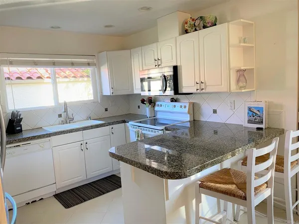 a view of a dining room with furniture and a window