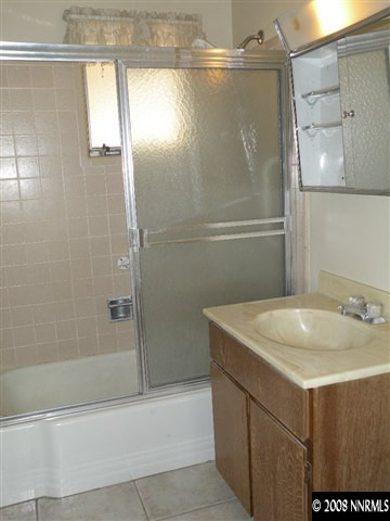1735 Auburn Way Reno, NV 89502 - Photo 8 of 9 a bathroom with a sink and mirror