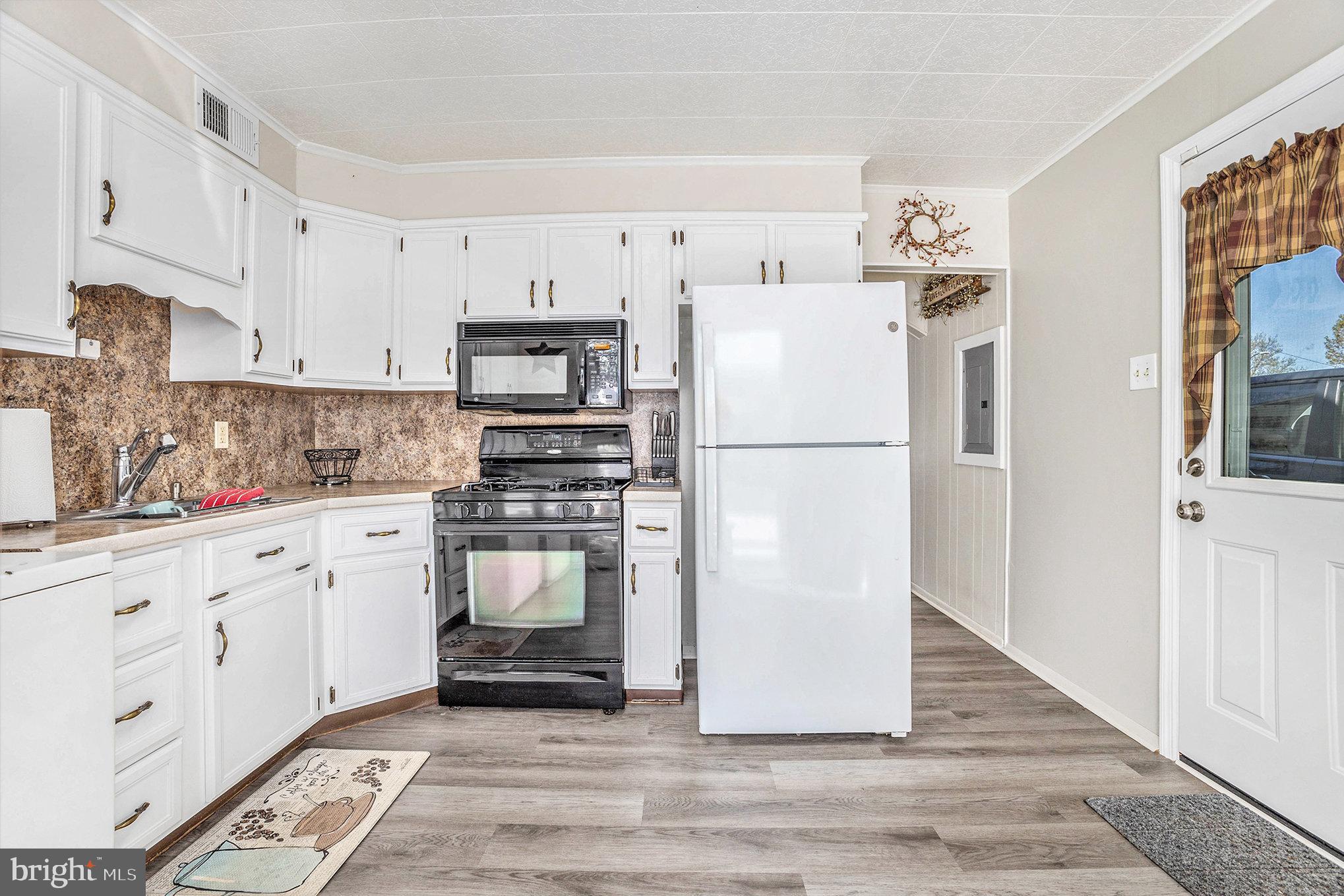 25 Constitution Avenue Eagleville, PA 19403 - Photo 8 of 24 a kitchen with stainless steel appliances white cabinets and a refrigerator