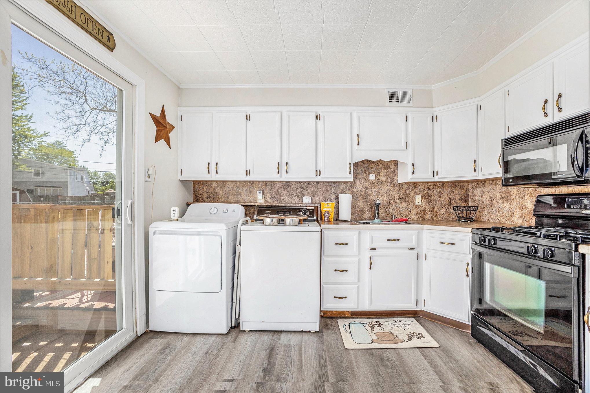 25 Constitution Avenue Eagleville, PA 19403 - Photo 9 of 24 a kitchen with a white cabinets and wooden floor