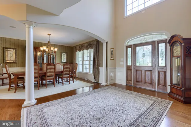 a bedroom with a bed a dresser and flat screen tv