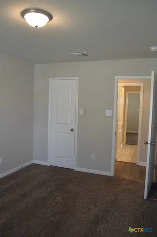 an empty room with closet area