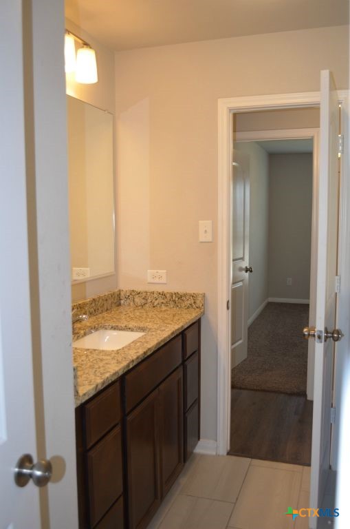 3414 Addison Street Killeen, TX 76542 - Photo 22 of 36 a bathroom with a granite countertop sink and a mirror
