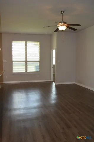 a view of a kitchen with a stove wooden floor and a chandelier