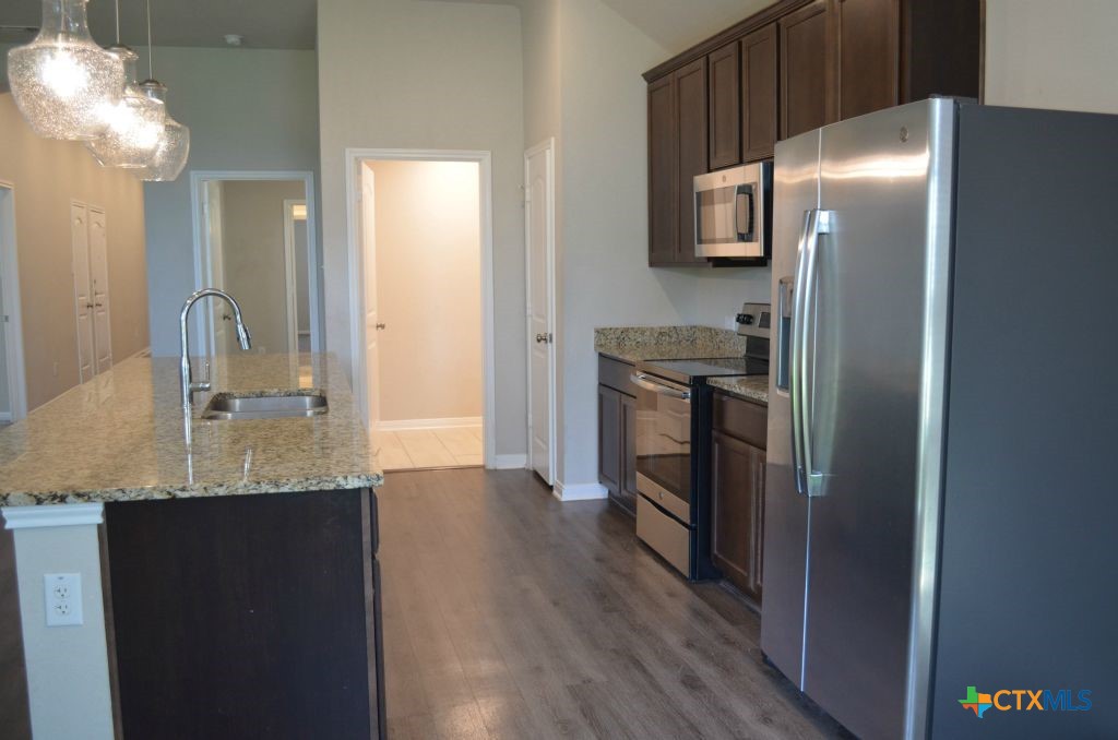 3414 Addison Street Killeen, TX 76542 - Photo 10 of 36 a kitchen with stainless steel appliances granite countertop a refrigerator and a sink