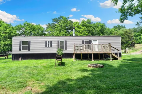 a kitchen with stainless steel appliances a refrigerator a stove a sink dishwasher a oven with wooden floor and cabinets