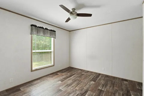 a view of an empty room and wooden floor