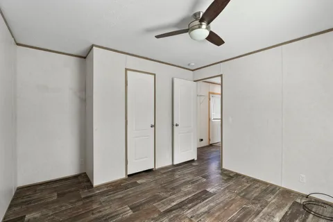 a balcony with wooden floor and yard in the back