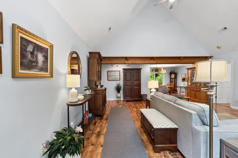 a view of a a dining room with furniture window and wooden floor