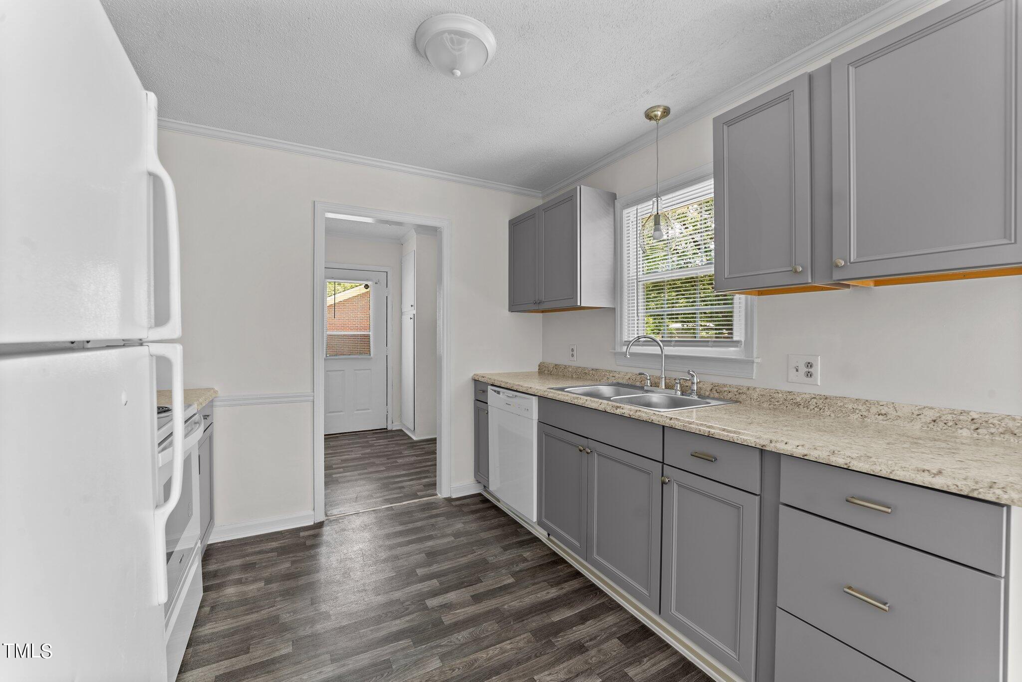 207 Freestone Road Greenville, NC 27834 - Photo 14 of 45 a kitchen with a sink cabinets appliances and a window