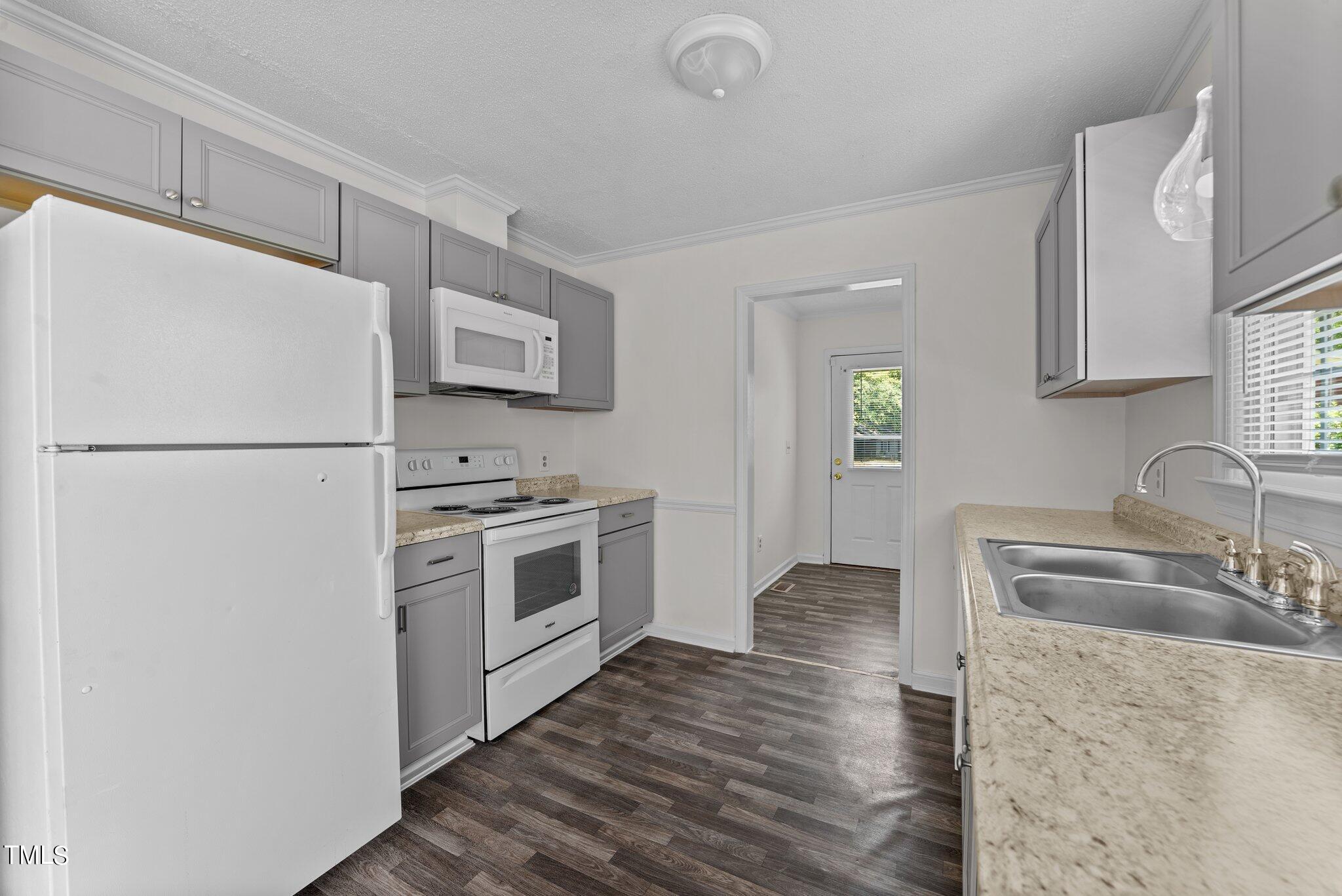 207 Freestone Road Greenville, NC 27834 - Photo 15 of 45 a kitchen with a refrigerator stove and sink