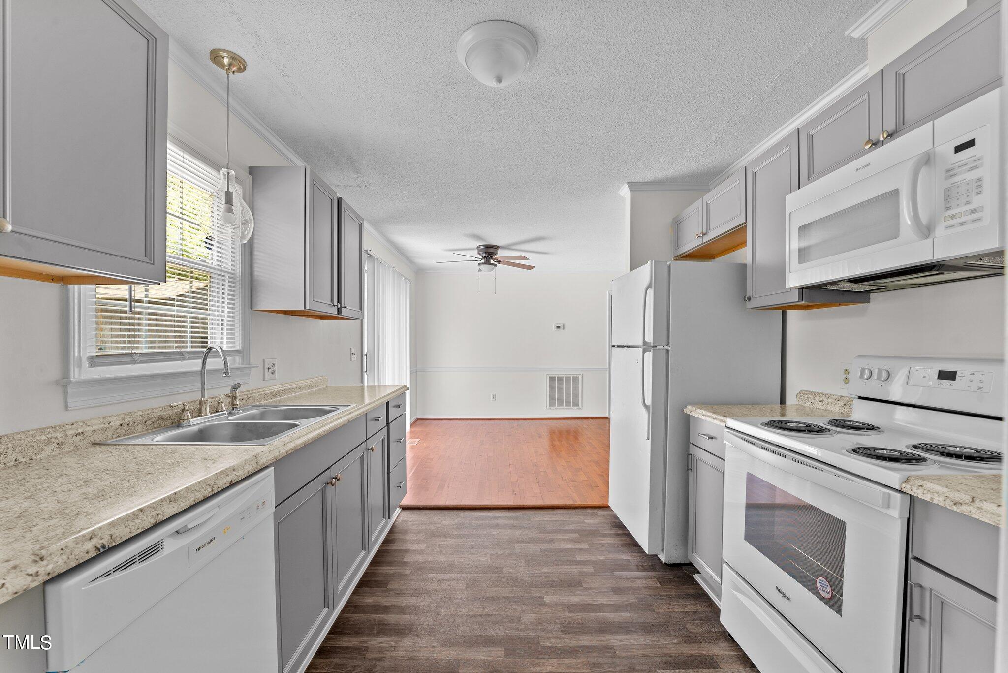 207 Freestone Road Greenville, NC 27834 - Photo 18 of 45 a kitchen with granite countertop a sink and a stove top oven