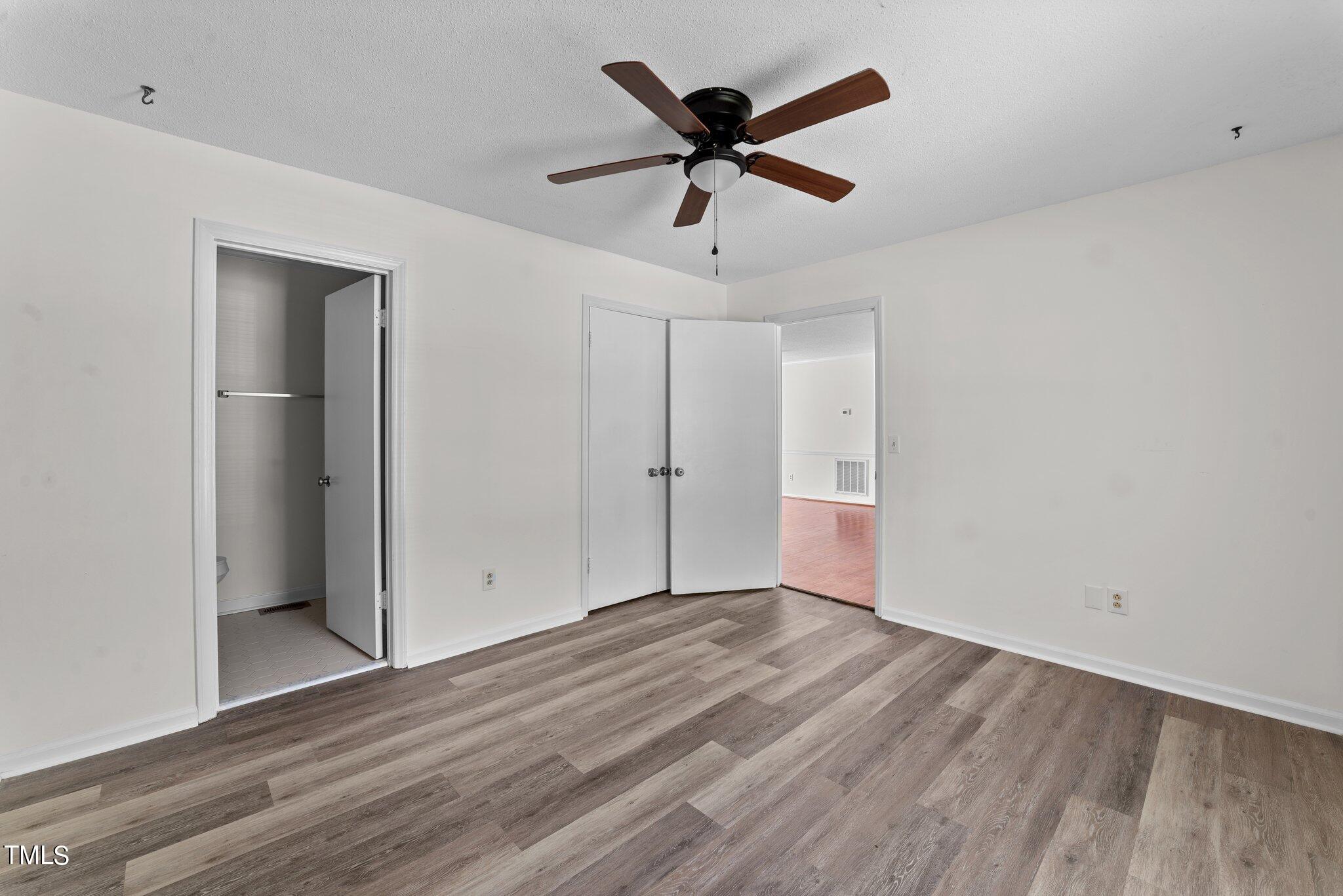 207 Freestone Road Greenville, NC 27834 - Photo 22 of 45 a view of empty room with wooden floor and ceiling fan