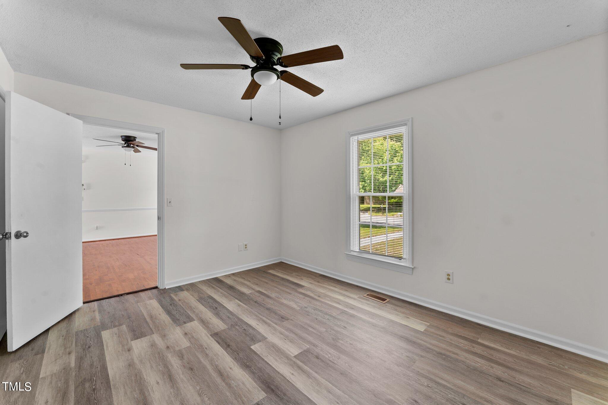 207 Freestone Road Greenville, NC 27834 - Photo 23 of 45 wooden floor in an empty room with a window