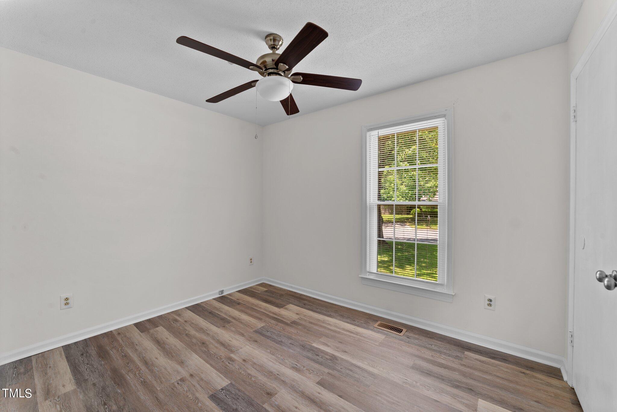 207 Freestone Road Greenville, NC 27834 - Photo 26 of 45 an empty room with a window and a ceiling fan