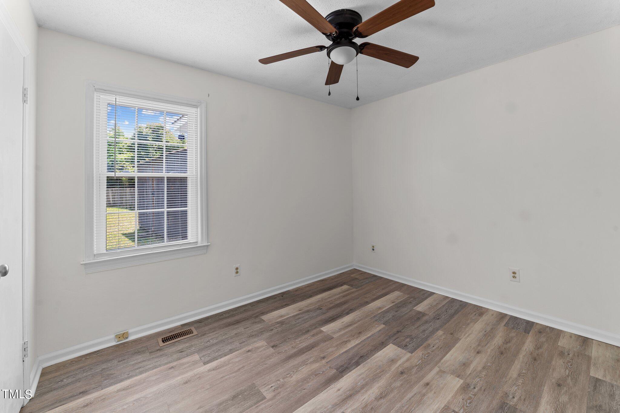 207 Freestone Road Greenville, NC 27834 - Photo 29 of 45 an empty room with a window and a fan