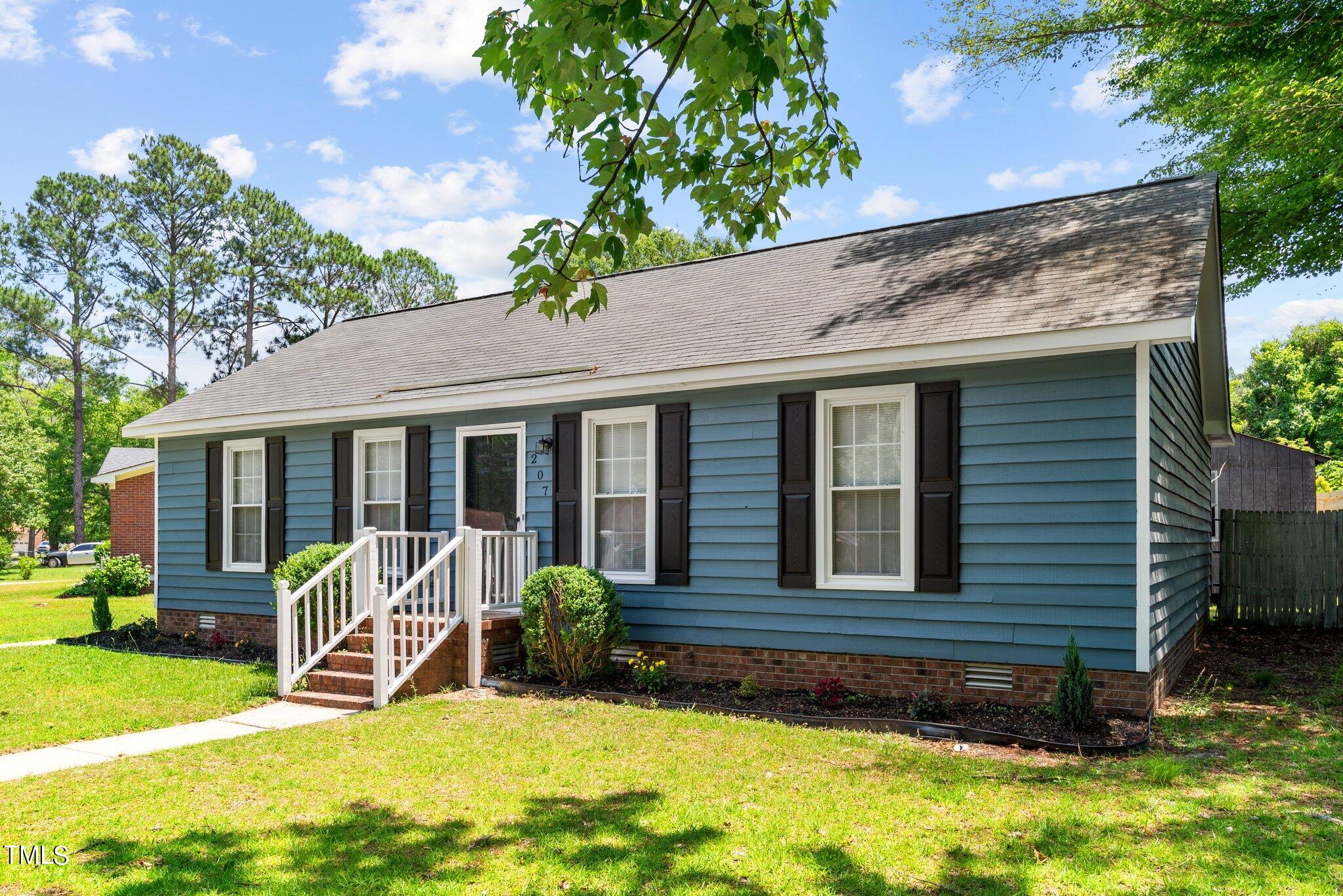 207 Freestone Road Greenville, NC 27834 - Photo 3 of 45 a view of a house with a yard patio and a large tree