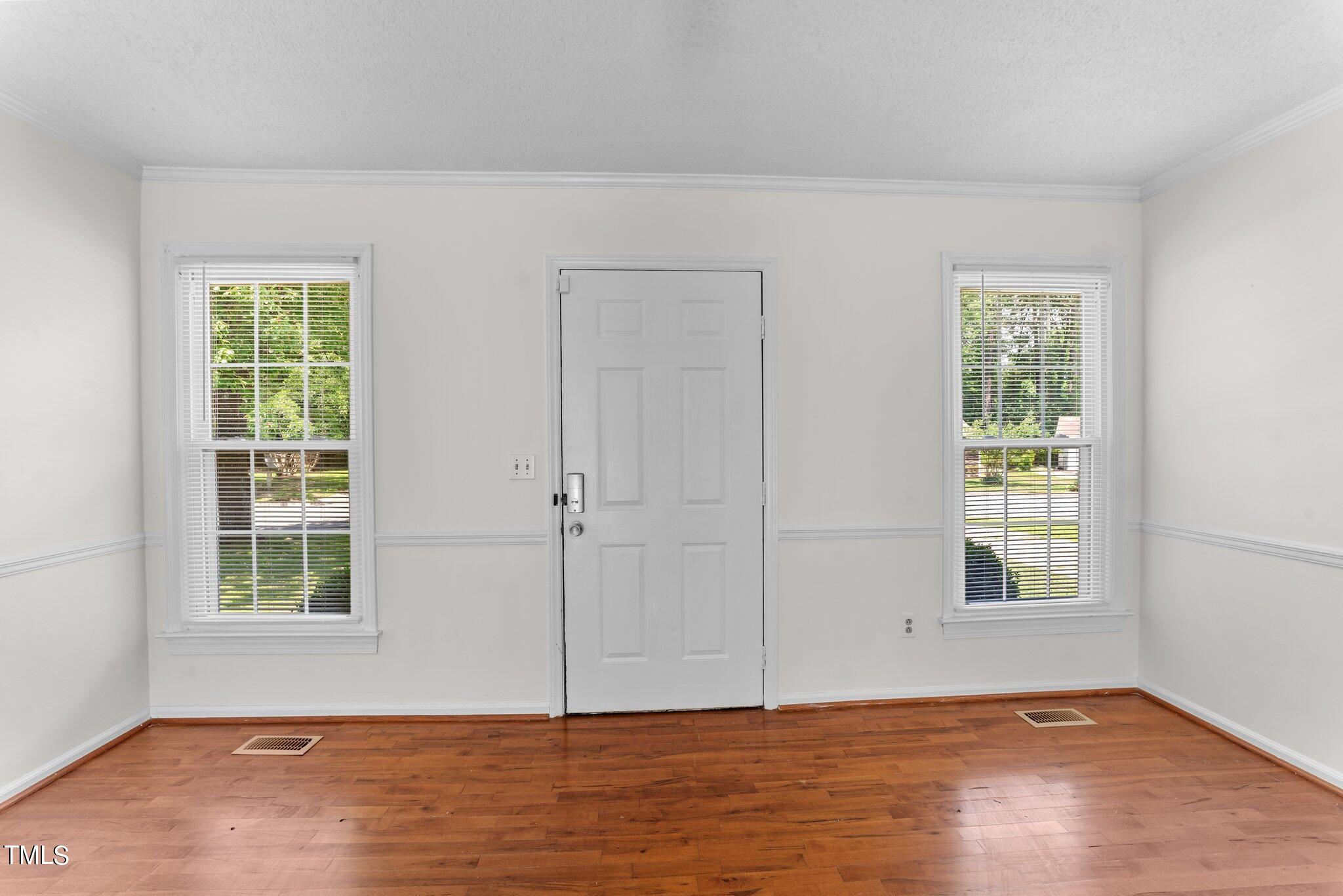 207 Freestone Road Greenville, NC 27834 - Photo 7 of 45 an empty room with wooden floor windows and closet