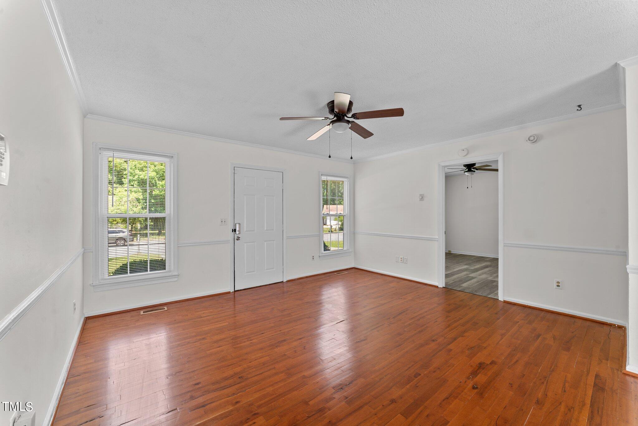207 Freestone Road Greenville, NC 27834 - Photo 9 of 45 an empty room with wooden floor and windows