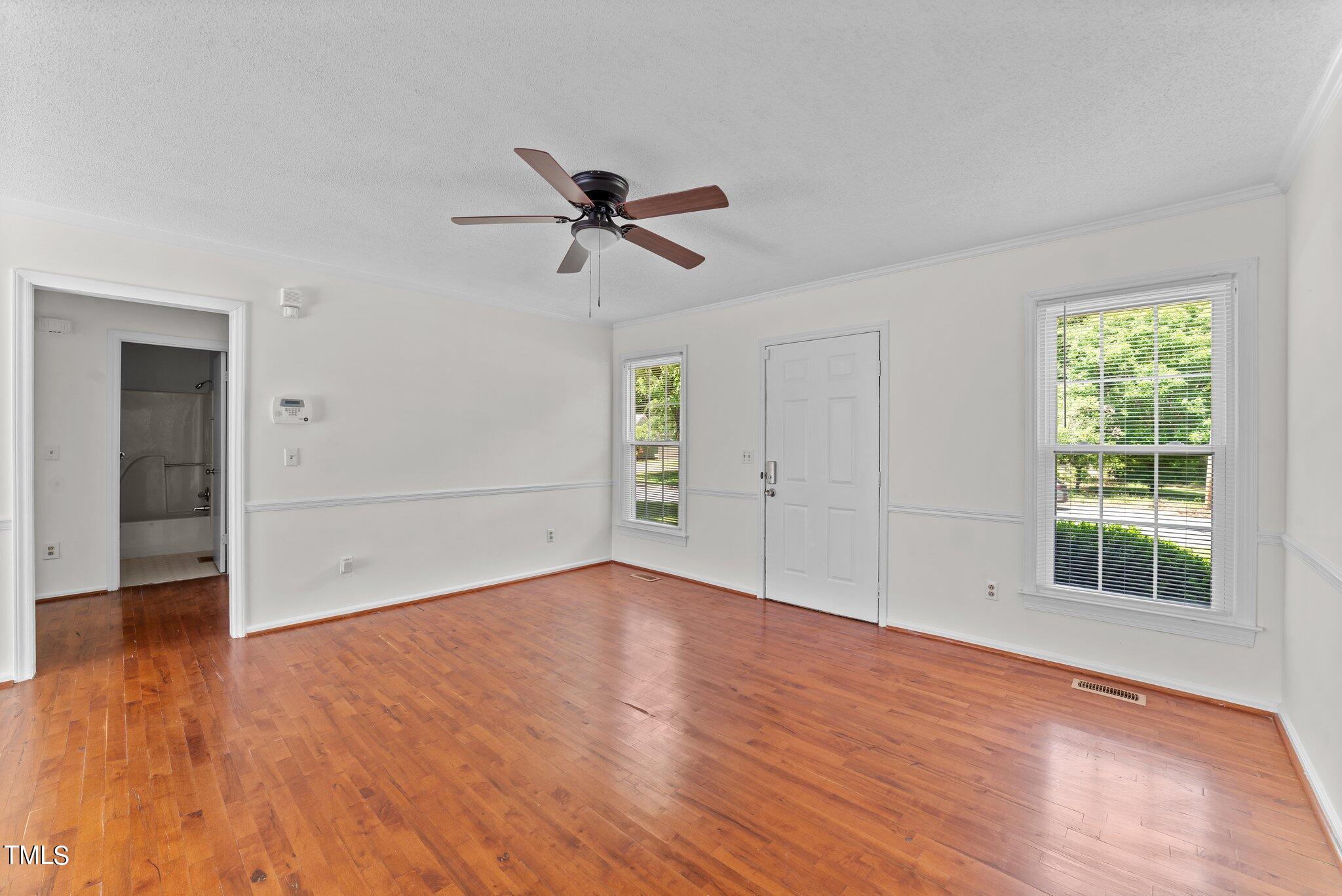 207 Freestone Road Greenville, NC 27834 - Photo 10 of 45 a view of empty room with wooden floor and ceiling fan
