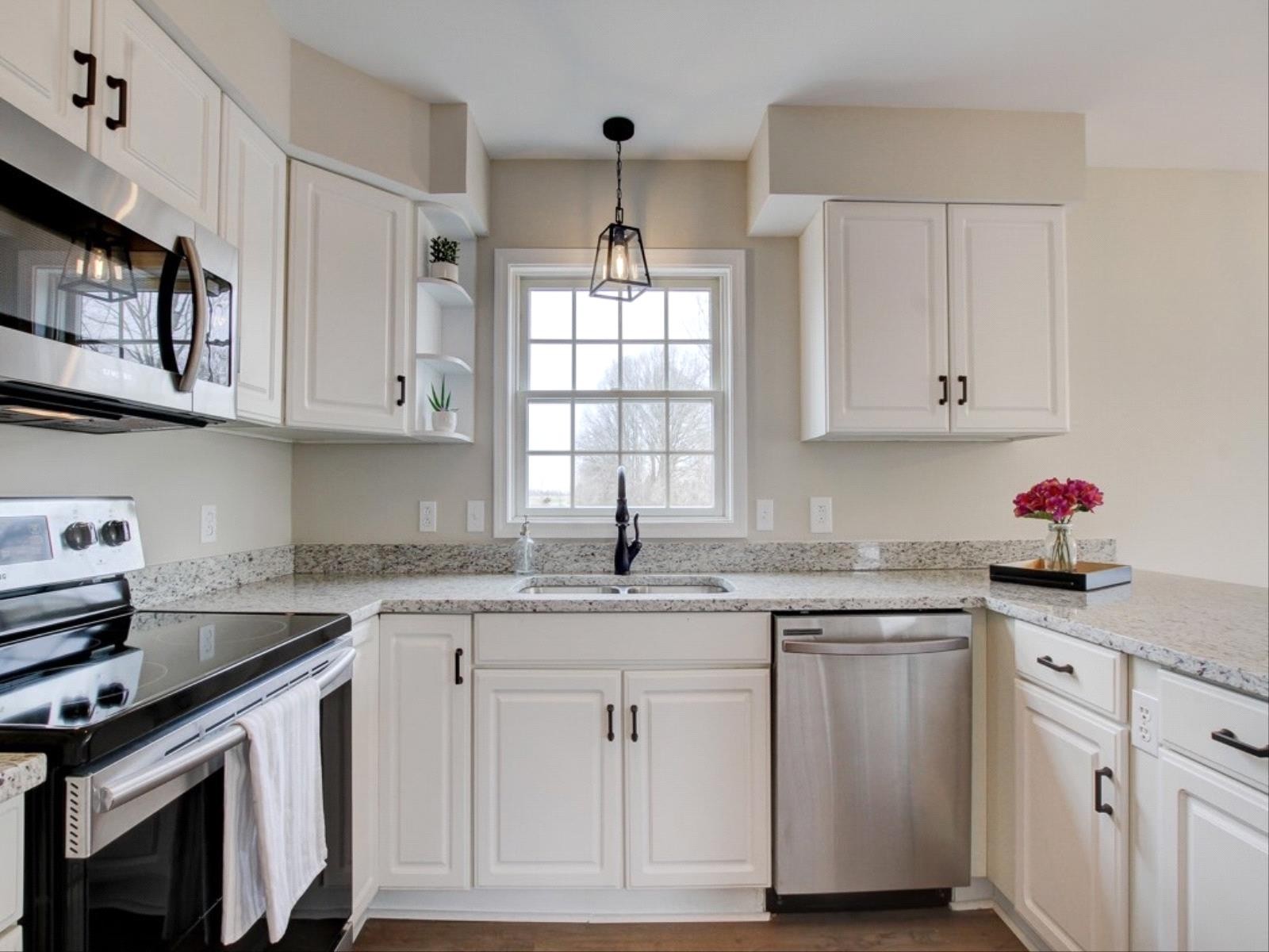 3408 Kinneys Road Cedar Hill, TN 37032 - Photo 8 of 19 a kitchen with granite countertop white cabinets white appliances and a sink