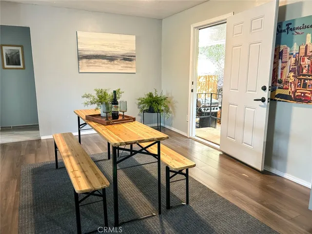 a dining room with furniture and wooden floor