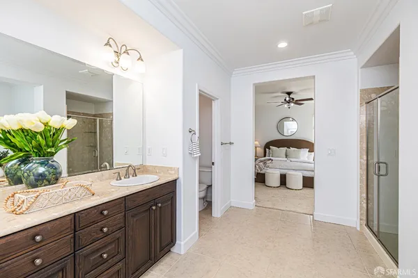 a bathroom with a granite countertop sink a mirror and a shower