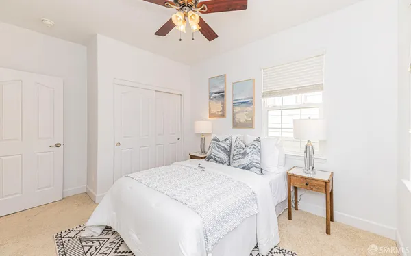 a bedroom with a bed and painting on the wall