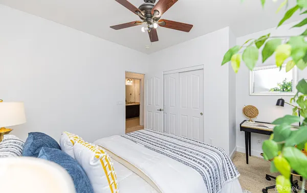 a bedroom with a bed and a lamp on table