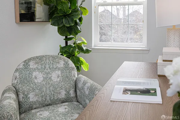 a living room with furniture and a potted plant