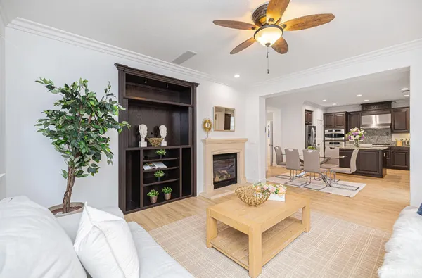 a living room with furniture a fireplace and a chandelier