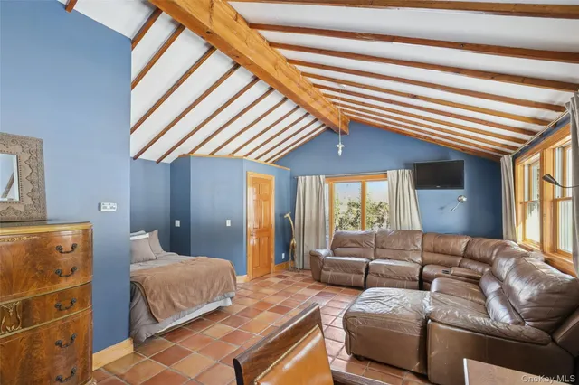 a bedroom with furniture and a large window