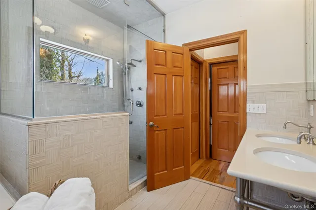 a bathroom with a sink a toilet and shower