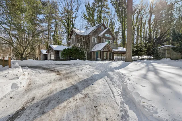 a view of a house with a yard covered in snow